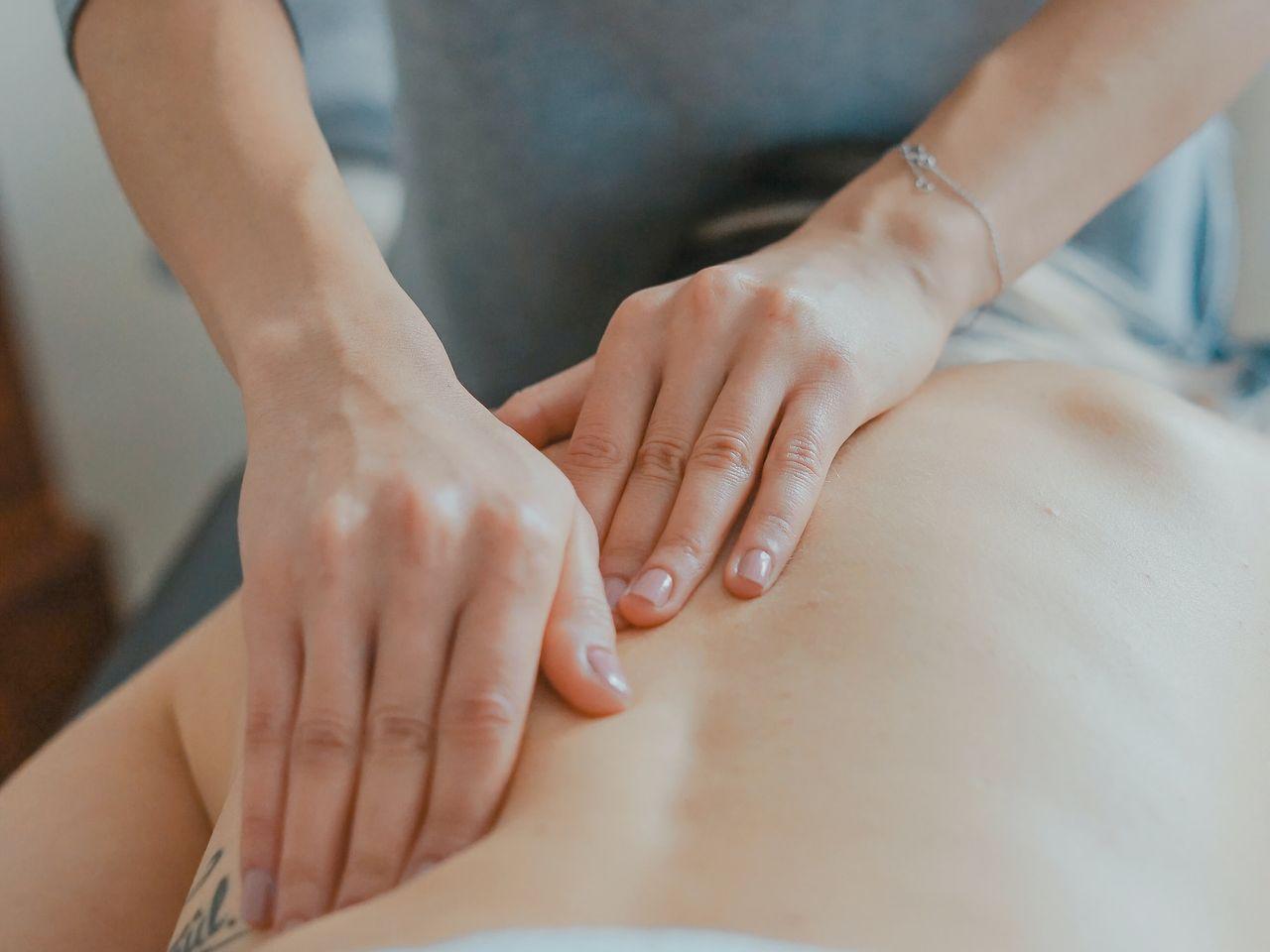 man massaging woman's body